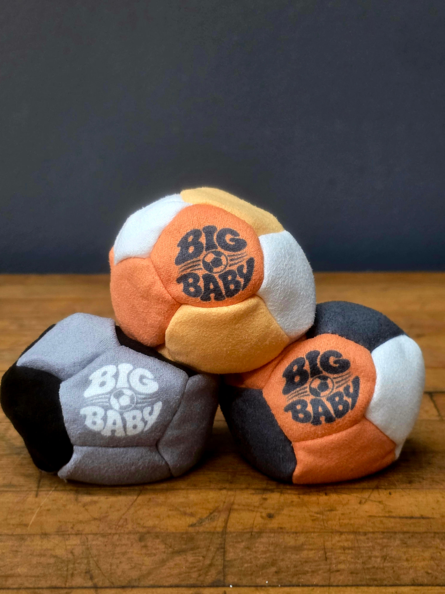 The Big Baby Sack — three 12-panel hand-stitched faux suede hacky sacks stacked together